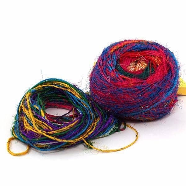 cake of yarn with yarn strings in different colors with a white background