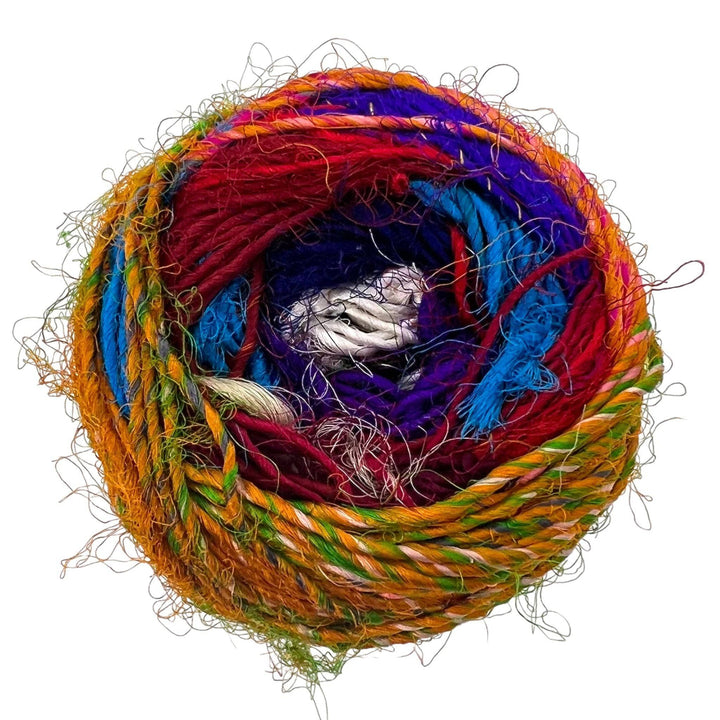 A skein of Recycled Silk Yarn in the colorway "Spice Market" sitting on a white background.