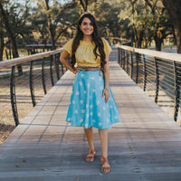 A woman standing on a wooden bridge.