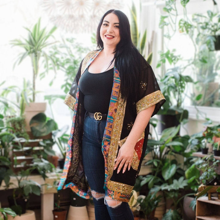 A woman wearing sophia embellished silk duster.