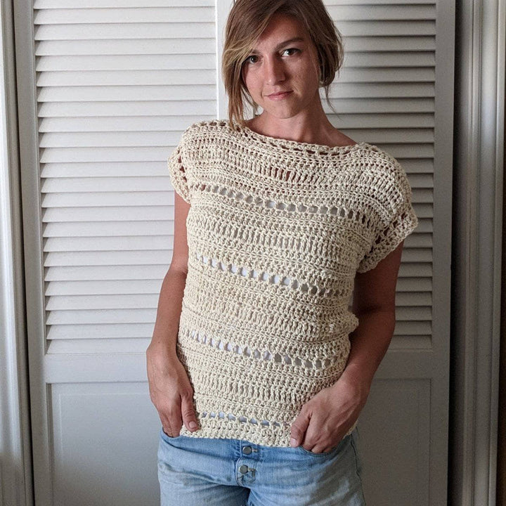 Woman wearing The Driftwood Tee in Dandelion Poof standing against white background
