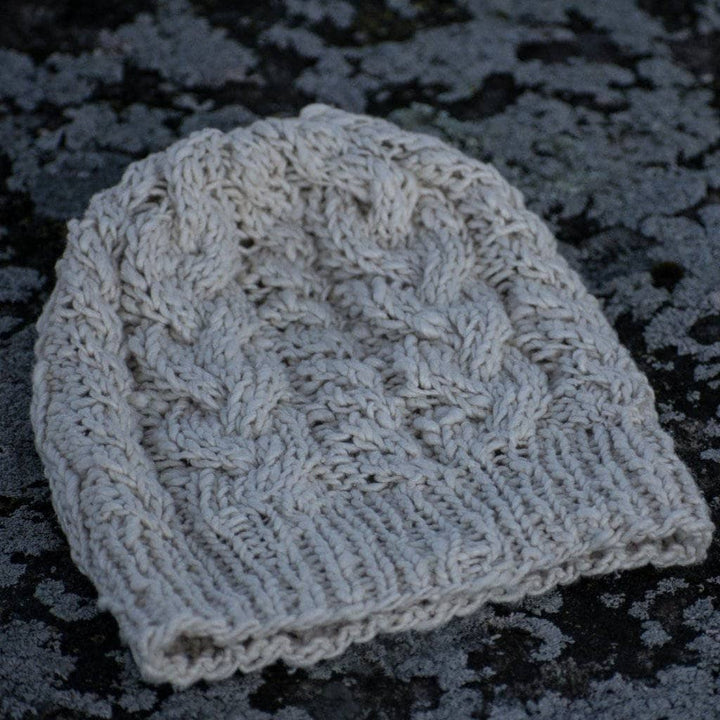 The Magnolia Beanie in Dandelion Poof (white) on a gray background