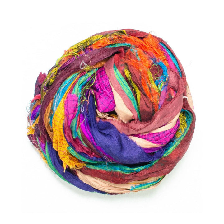 multicolor finished edge ribbon yarn in front of a white background. 