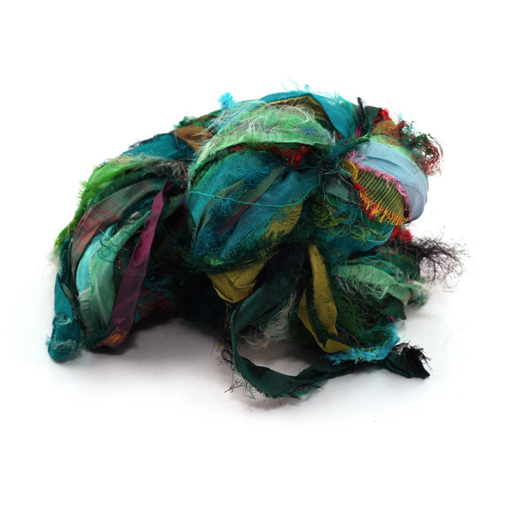 Windswept Ribbon yarn ball in Green on a white background