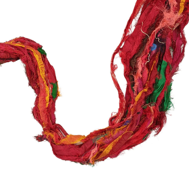 A close up of red recycled chiffon ribbon yarn.