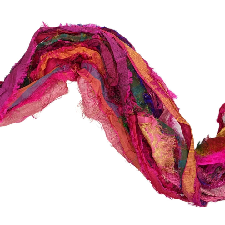 A close up of pink recycled chiffon ribbon yarn.