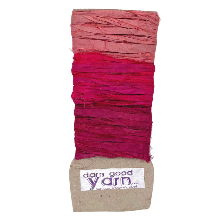 3 shades of red sari silk ribbon yarn on a white background