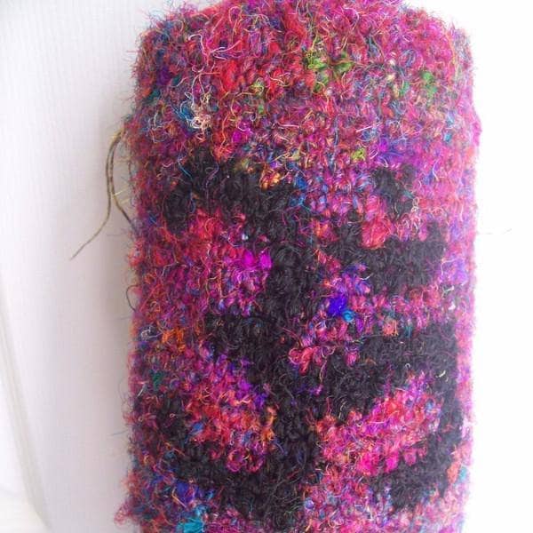 Yoga Mat Carrying Bag crocheted in pink yarn with black om symbol on a white background