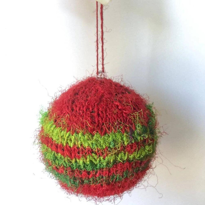 Red and green striped Christmas ornament on a white background