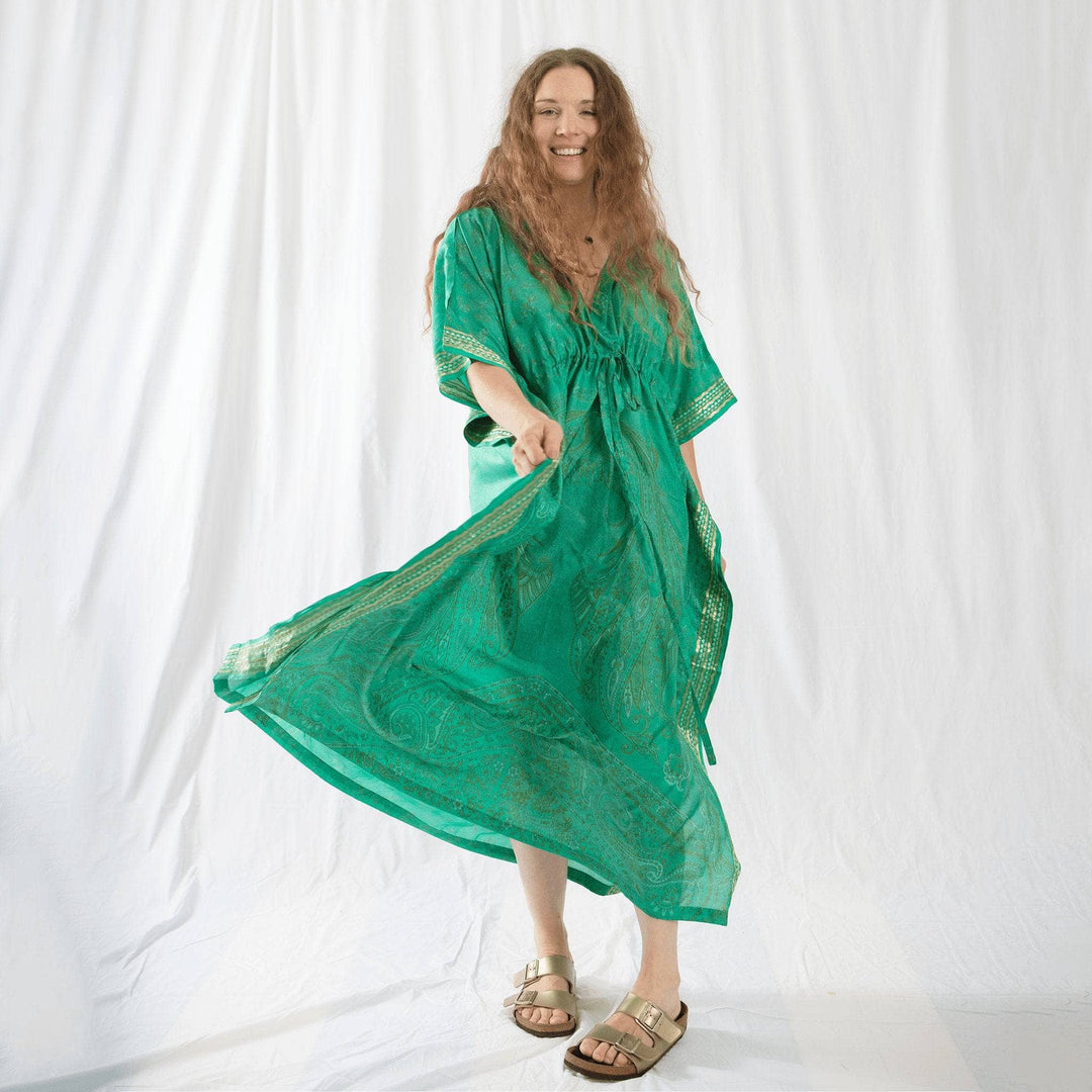 Founder Nicole wearing an emerald green silk kaftan dress. 