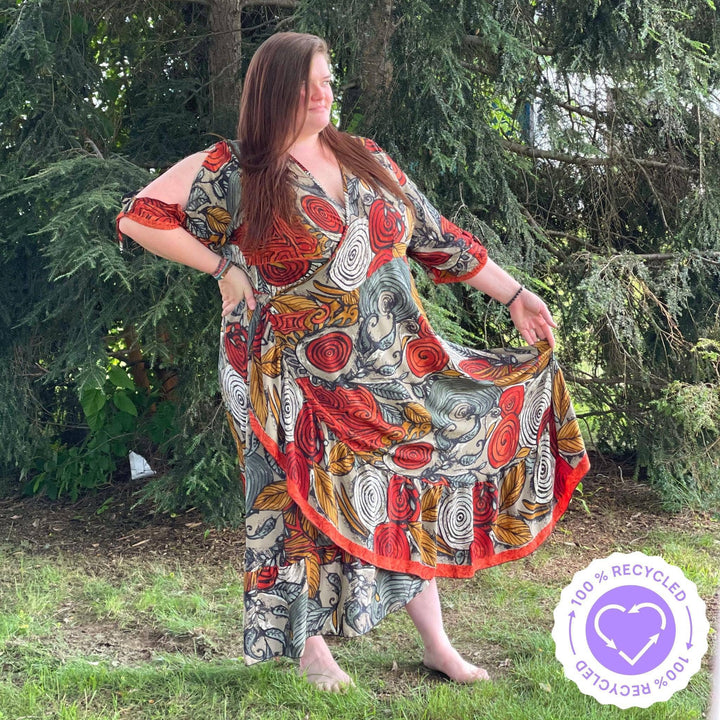 Girl in the park wearing a warm tone Zaria wrap dress in size Goddess. Showing how the fabric flows.