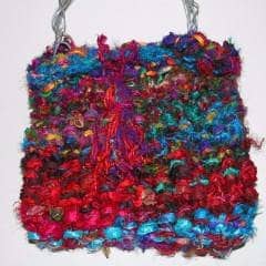 20,000 Leagues Under the Sea Purse in red and blue sitting on a white background