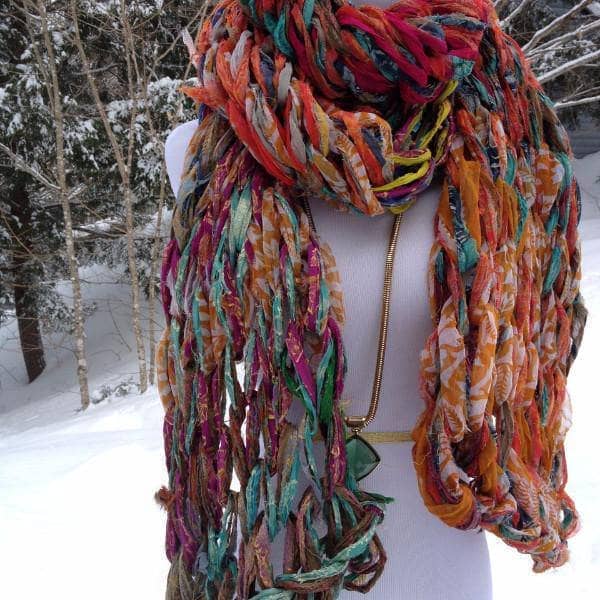 Mannequin wearing 30 Minute Arm Knit Scarf standing in the snow