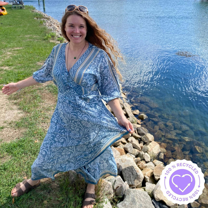 Darn Good Yarn Founder Nicole Snow near a lake wearing a cool blue Zaria Wrap Dress in size Womens