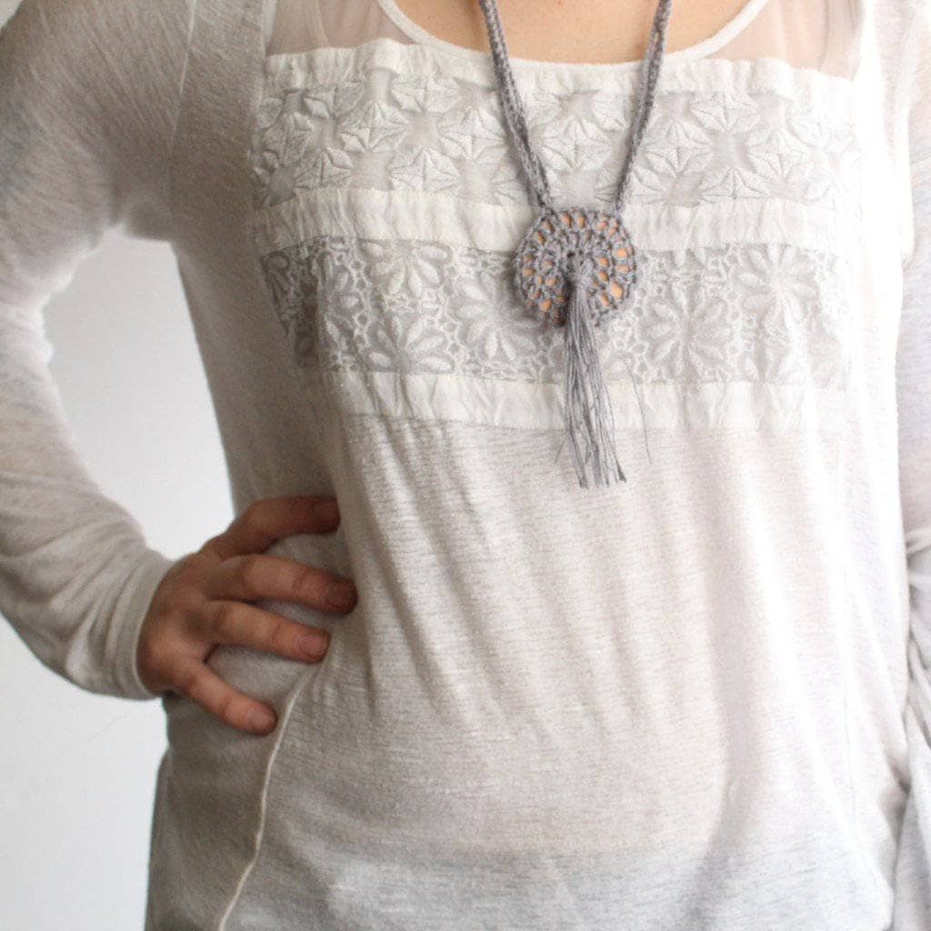 Woman wearing white shirt and Boho Macrame Necklace in gray