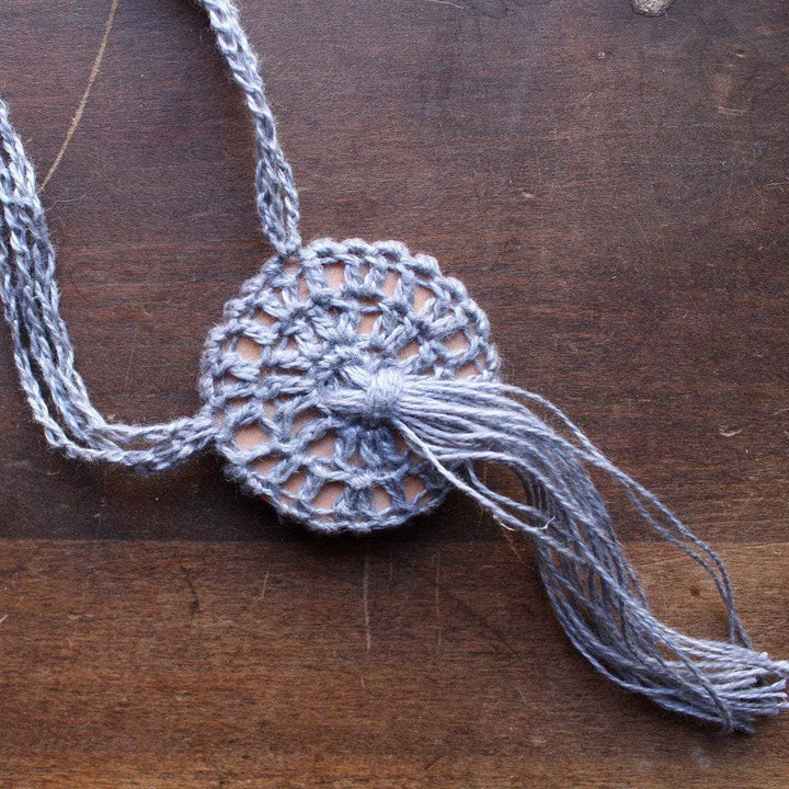 Boho Macrame Necklace in gray on a wooden background