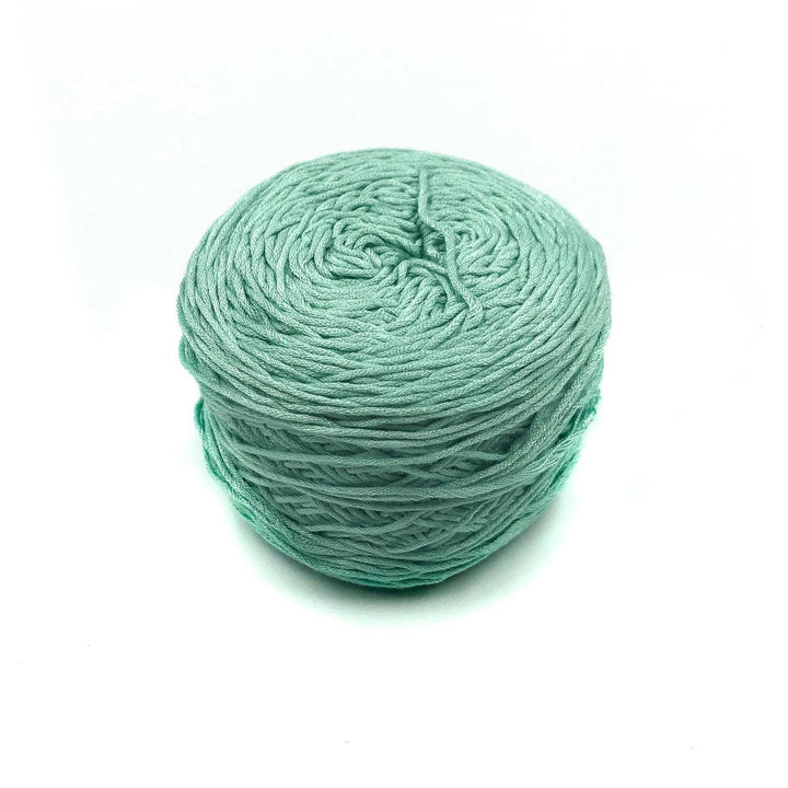 Viscose & Cotton Baby Yarn cake in Baby Cosmos (green) on a white background