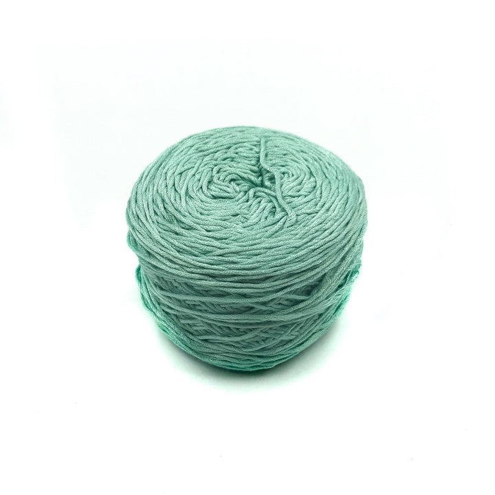 Viscose & Cotton Baby Yarn cake in Baby Cosmos (green) on a white background