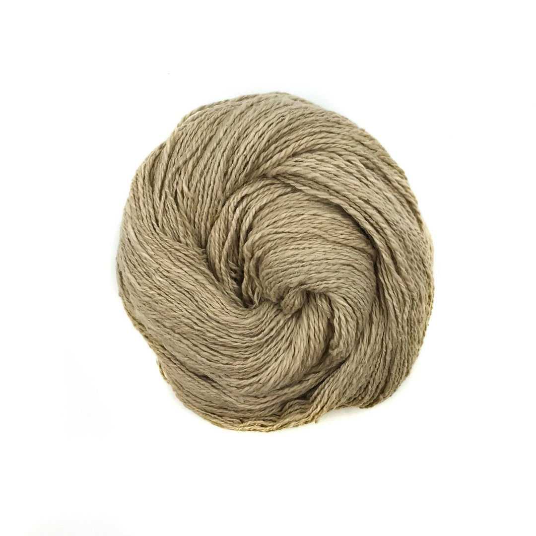 close up of yarn in the color fresh Mimosa Legume (beige) with a white background