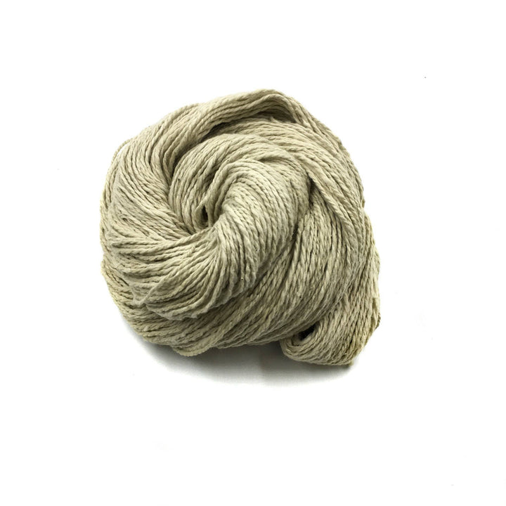 close up of yarn in the color topiary (beige) with a white background