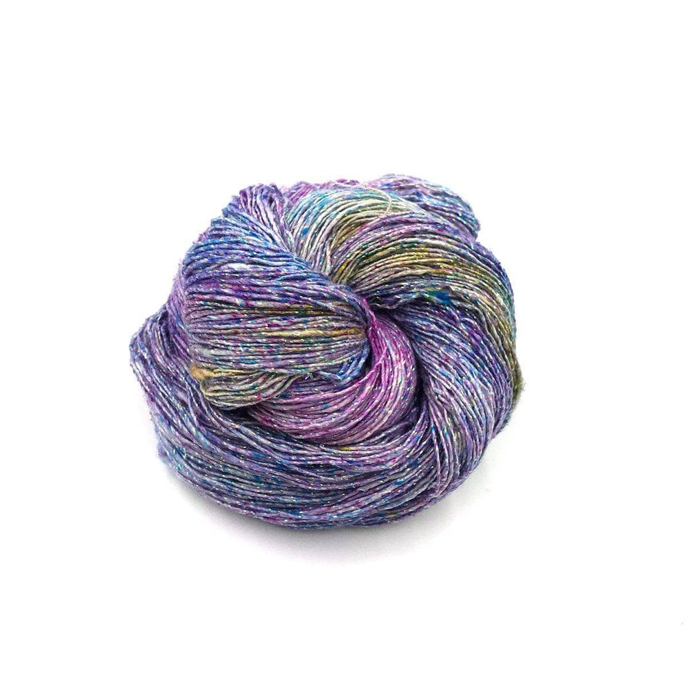 Sparkle lace weight silk yarn in Tidal Pool (purple, blue) on a white background