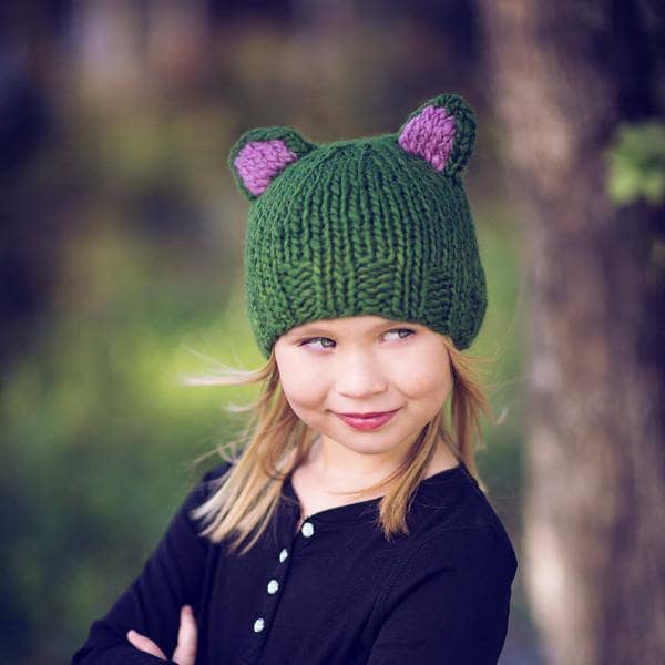 Kid smiling wearing a Forest Friends Wool Hat outdoors