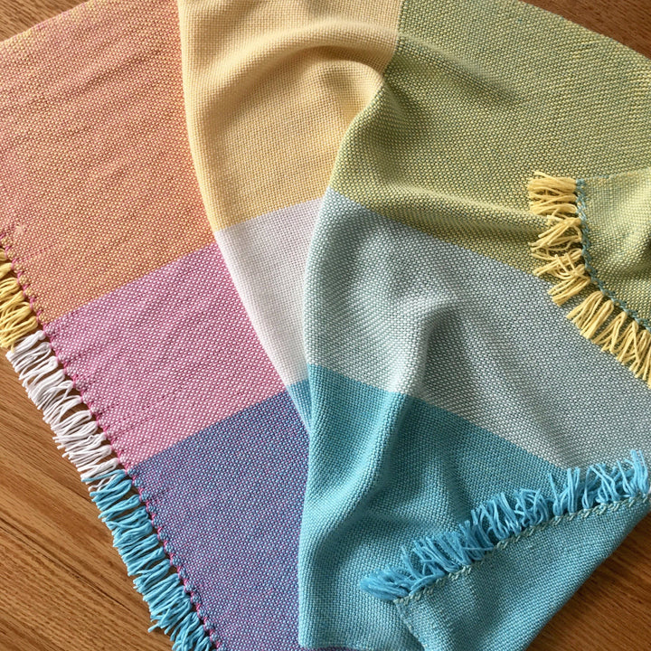 multicolored blanket on a wood background