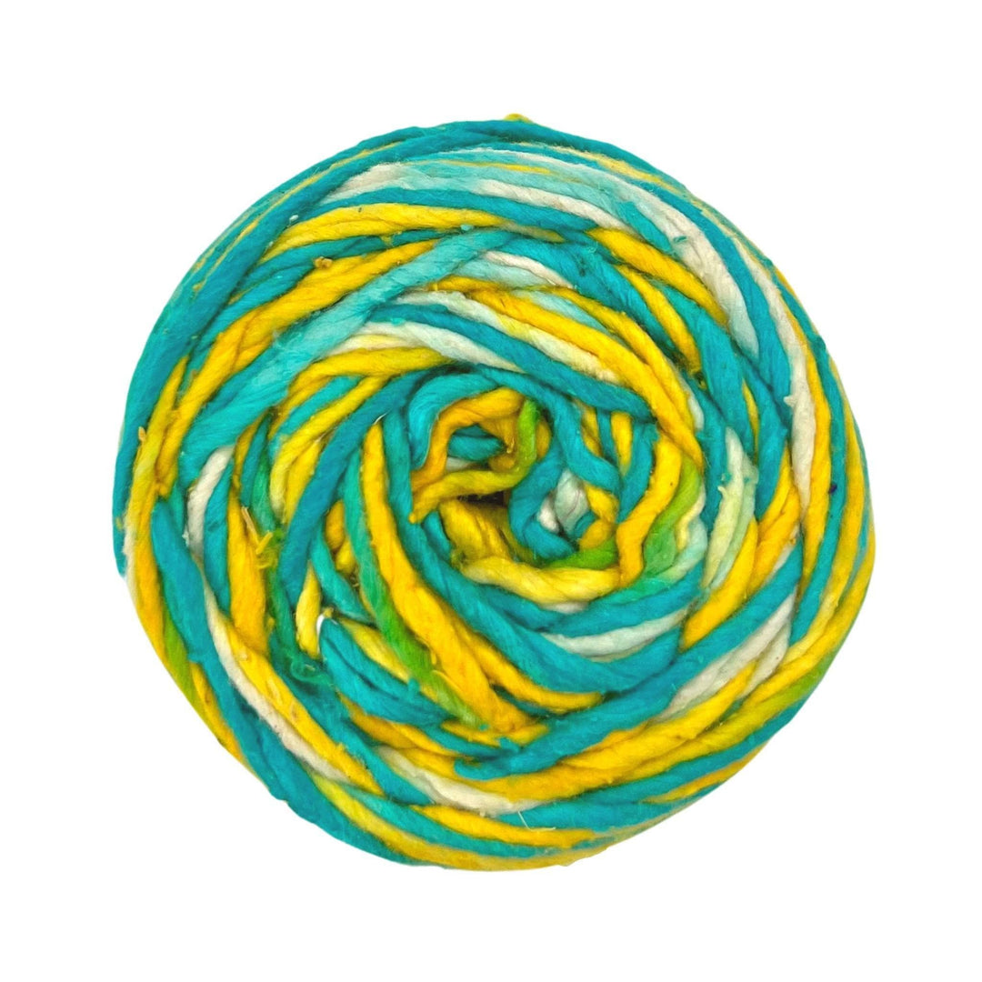 skein of yellow and blue worsted weight recycled silk yarn in front of a white background.  