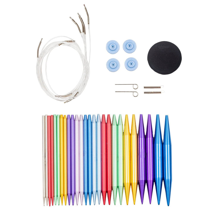 All items from aluminum interchangeable knitting needle set in front of a white background. 13 sets of aluminum knitting needles in assorted colors, 4 clear connector cables, 4 end caps for needles, 2 turn keys, 2 connector extenders, and one handy grip tool.