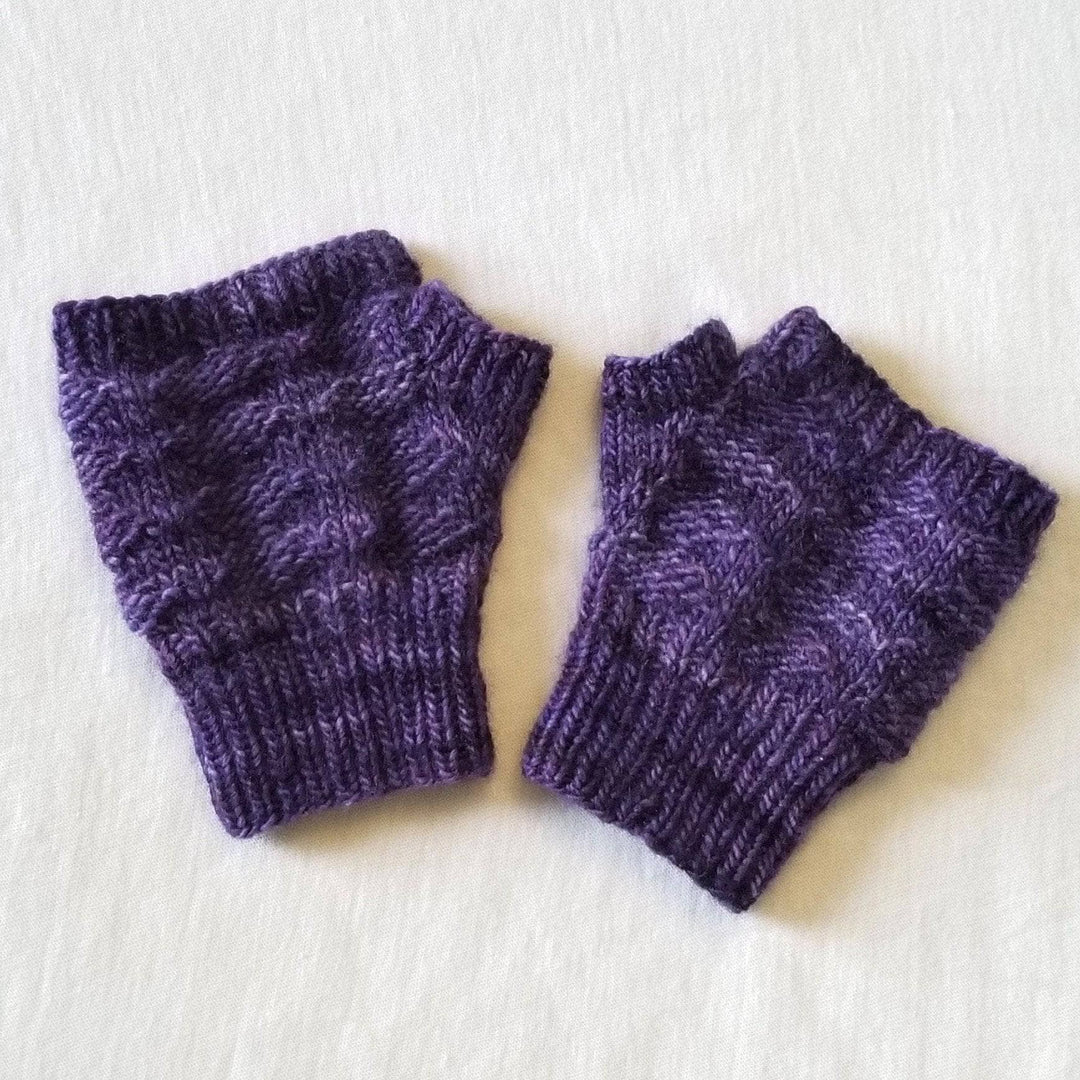 2 knit purple fingerless mitts using a textured stitch in front of a white background.