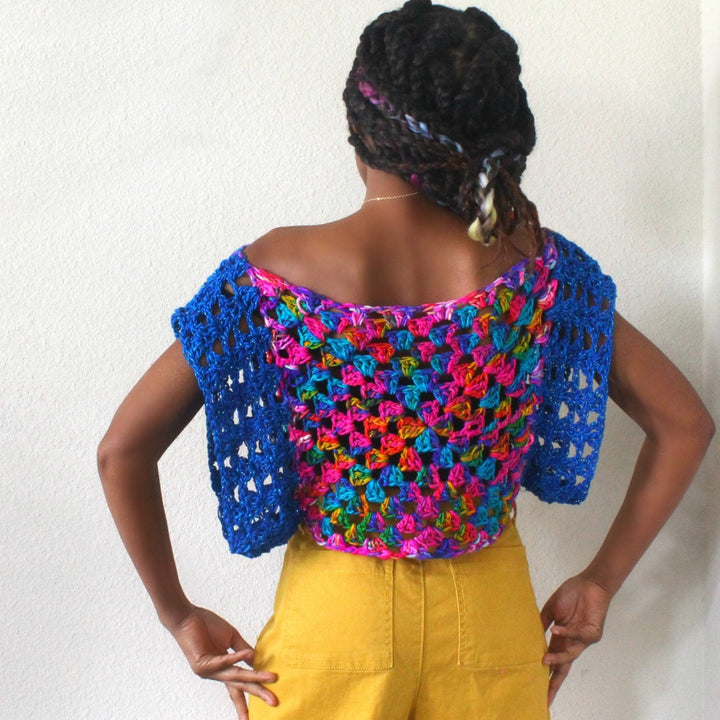 Back view of designer wearing easy crochet top in front of a white background.
