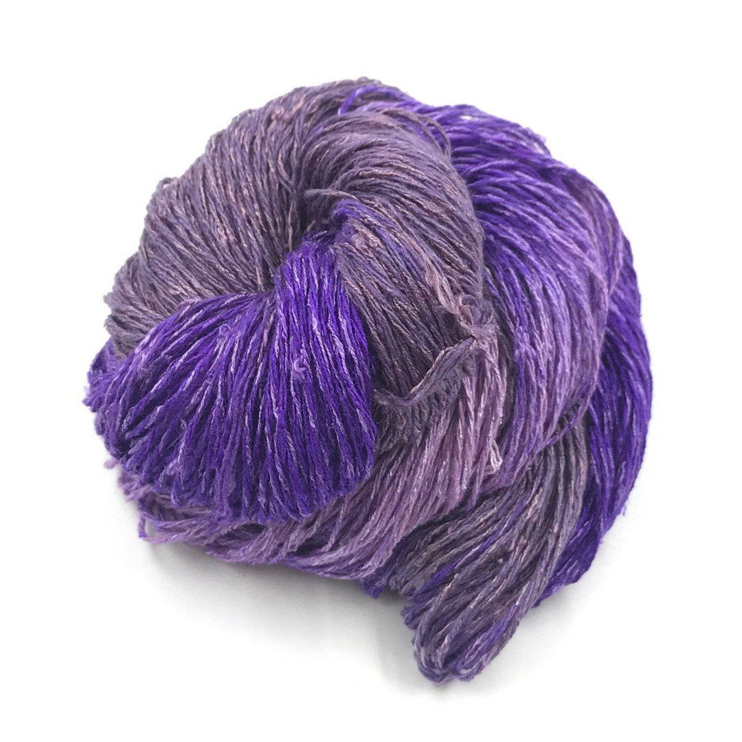 a skein of purple and lighter purple on a white background