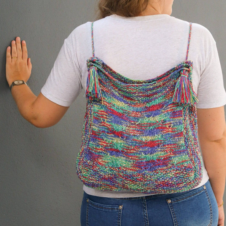 a multicolored bag on a person