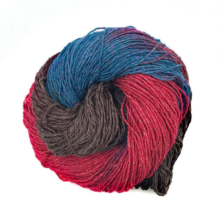 a skein of brown, blue and red skein of yarn on a white backgroun