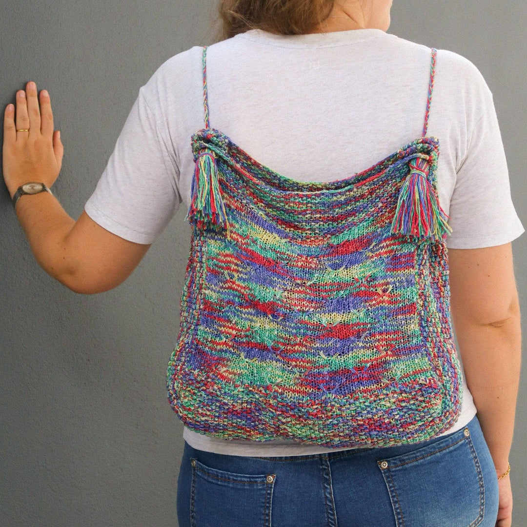 a multicolored bag on a person