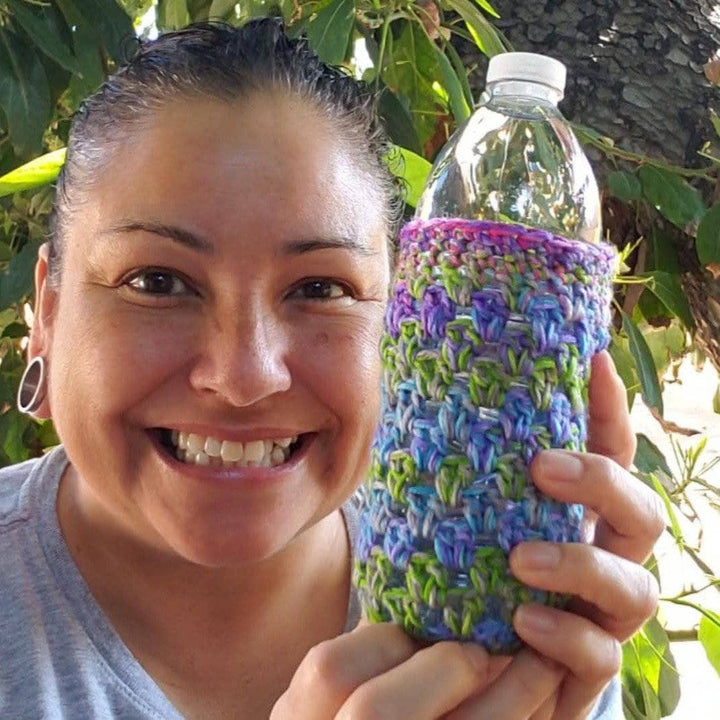 women holding a water bottle with a koozie on it 