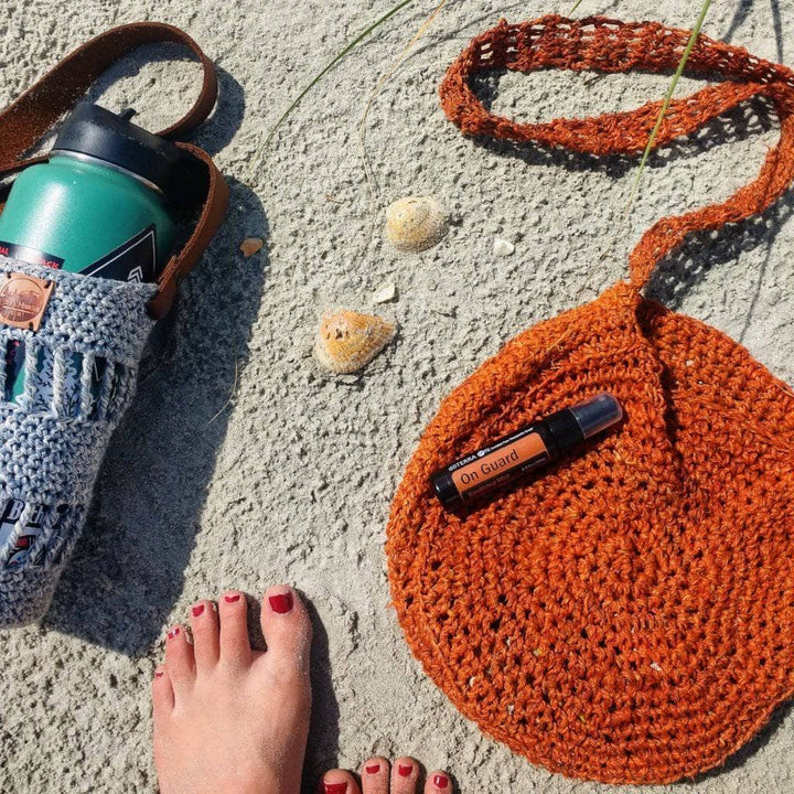 Beach Day Bag Crochet shoulder bag in Rust (burnt orange) on a sandy beach