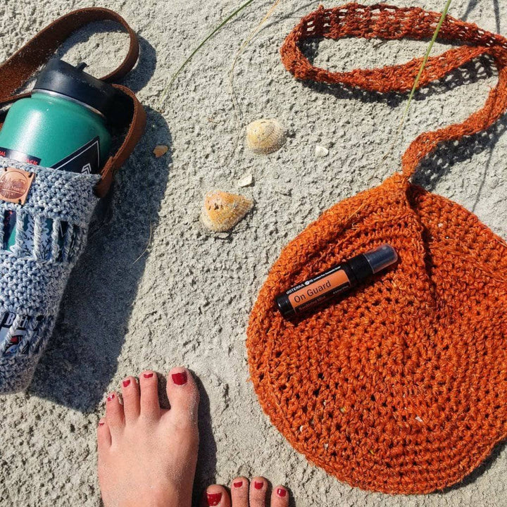 Beach Day Bag Crochet shoulder bag in Rust (burnt orange) on a sandy beach