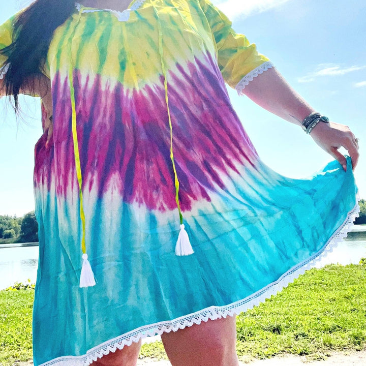 Close-up of brilliant  tie-dye coverup. A lake is in the background.