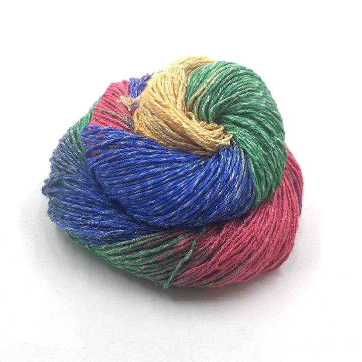 Silk blend sport weight yarn donut ball in Rainbow on a white background