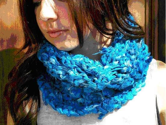 Woman wearing a blue knit cowl scarf