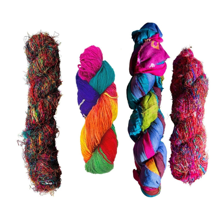 the best of dgy pack in front of a white background. Left to right is the banana fiber kaleidoscope, sport weight holi, at the bahamas sari silk ribbon yarn, and premium sari silk handspun.
