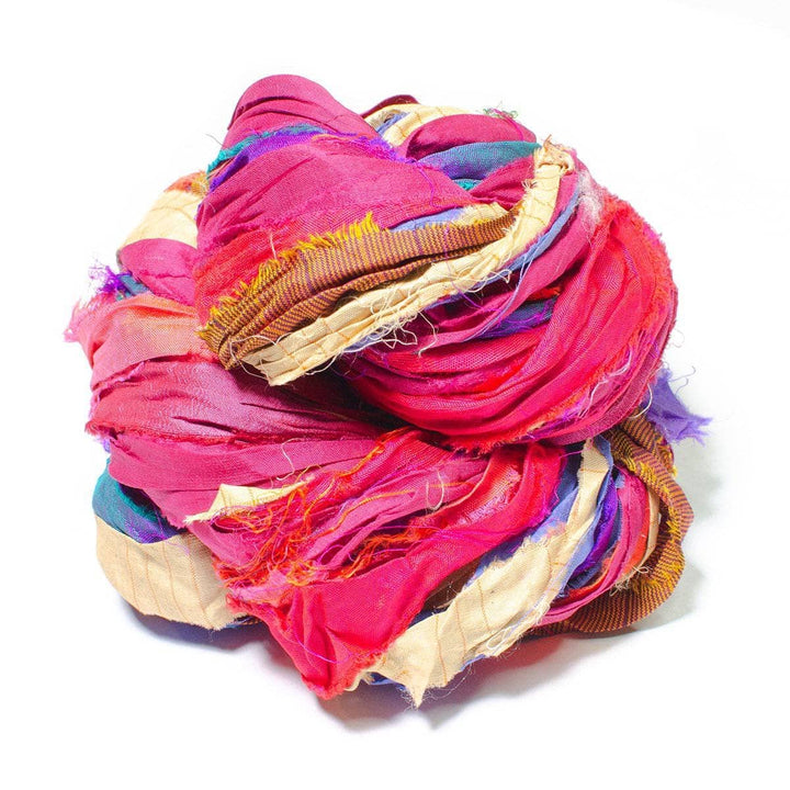 a skein of multicolored ribbon yarn on a white background