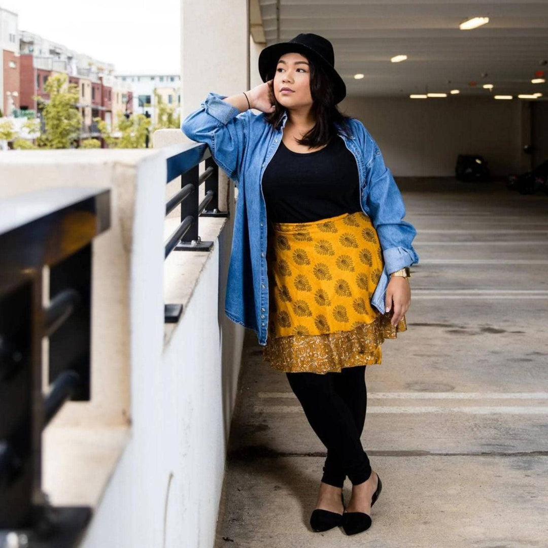 A model standing on a balcony wearing a Plus 08-20 Sari Wrap Skirt in a mini length.