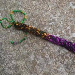 Purple Braided Bracelet laying on a concrete background