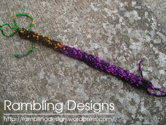 Purple Braided Bracelet laying on a concrete background