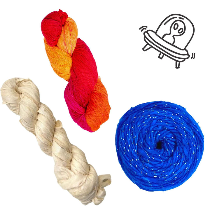 Pluto solar system yarn pack in front of a white background with black graphic in upper right. Lace weight silk color surge, sparkle worsted weight silk classic blue, sari silk ribbon yarn vintage ivory.