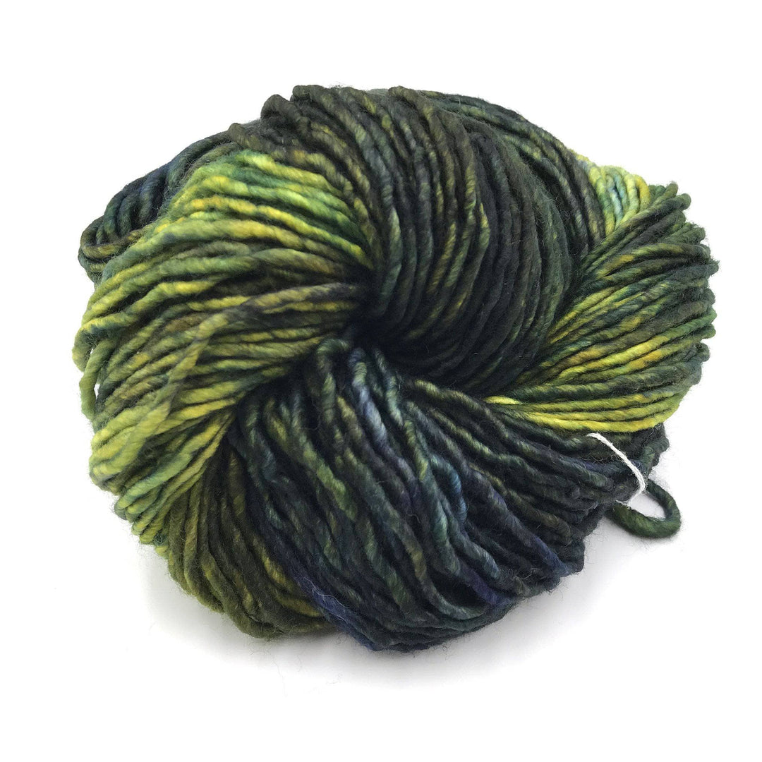 A multi-shaded green skein of yarn on a white background