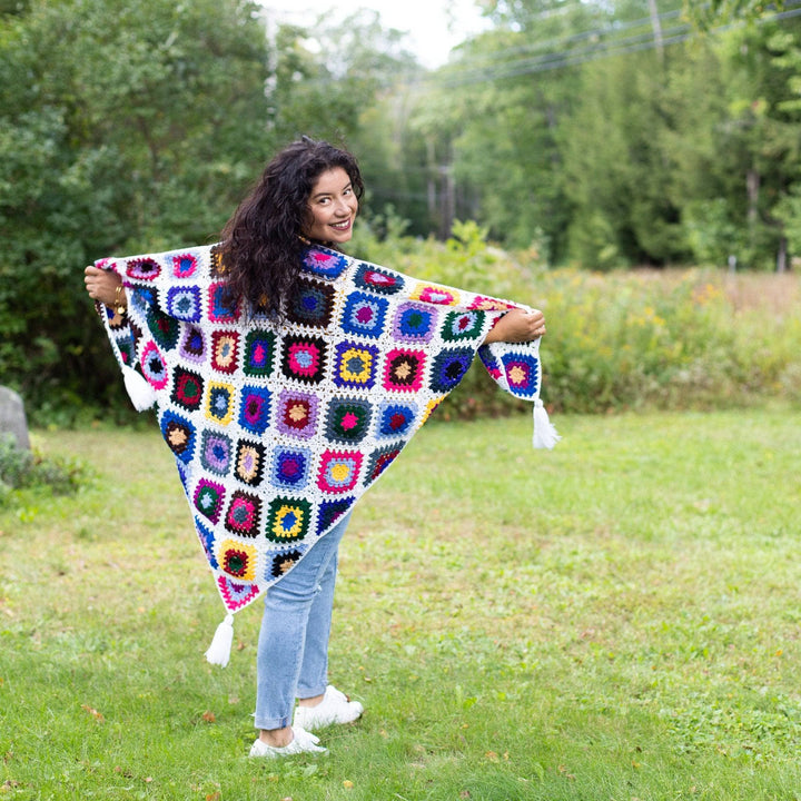 girl wearing cape cod granny square shawl in green fields