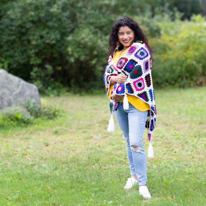 girl wearing cape cod granny square shawl in green fields